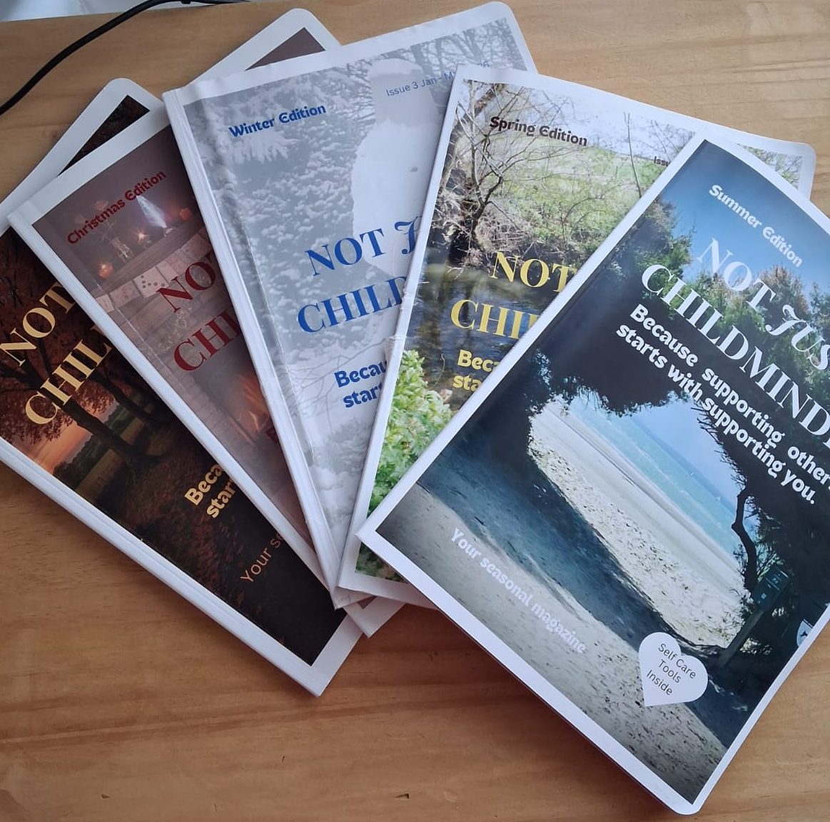 All 5 issues of Not JUST a Childminder magazine displayed on table